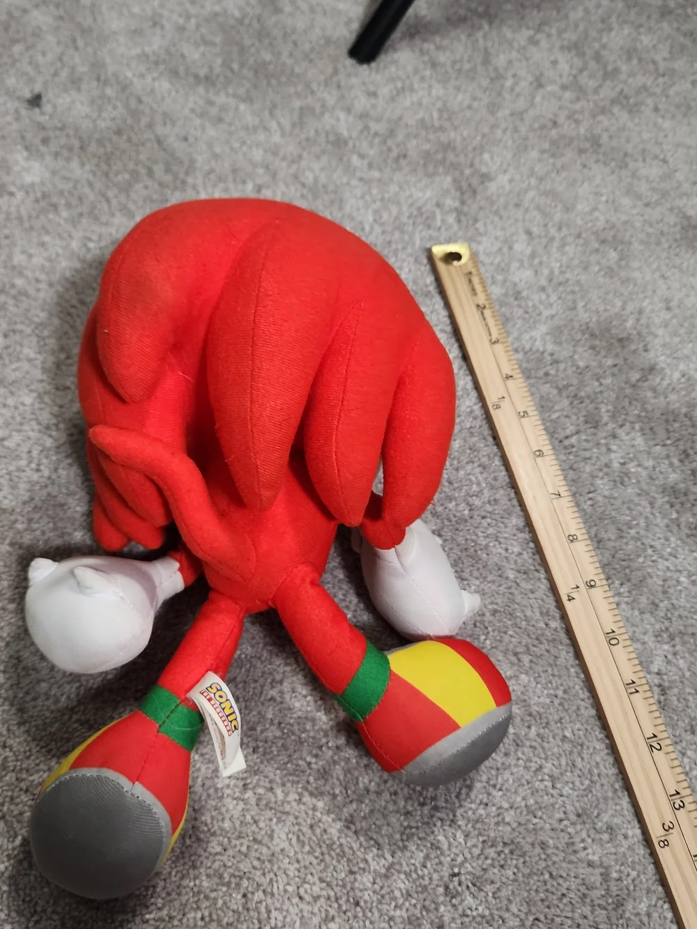 Red Plush Character Toy with White Gloves and Multicolor Shoes
